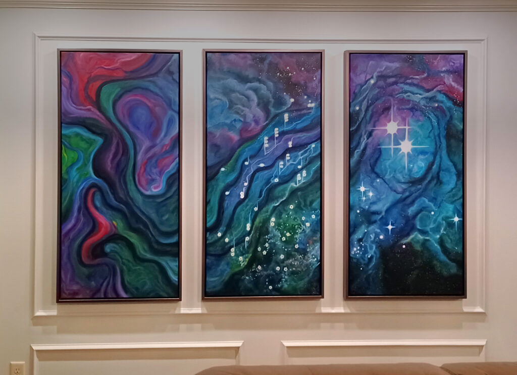 Image of a three-panel astronomical painting installed on a wall.